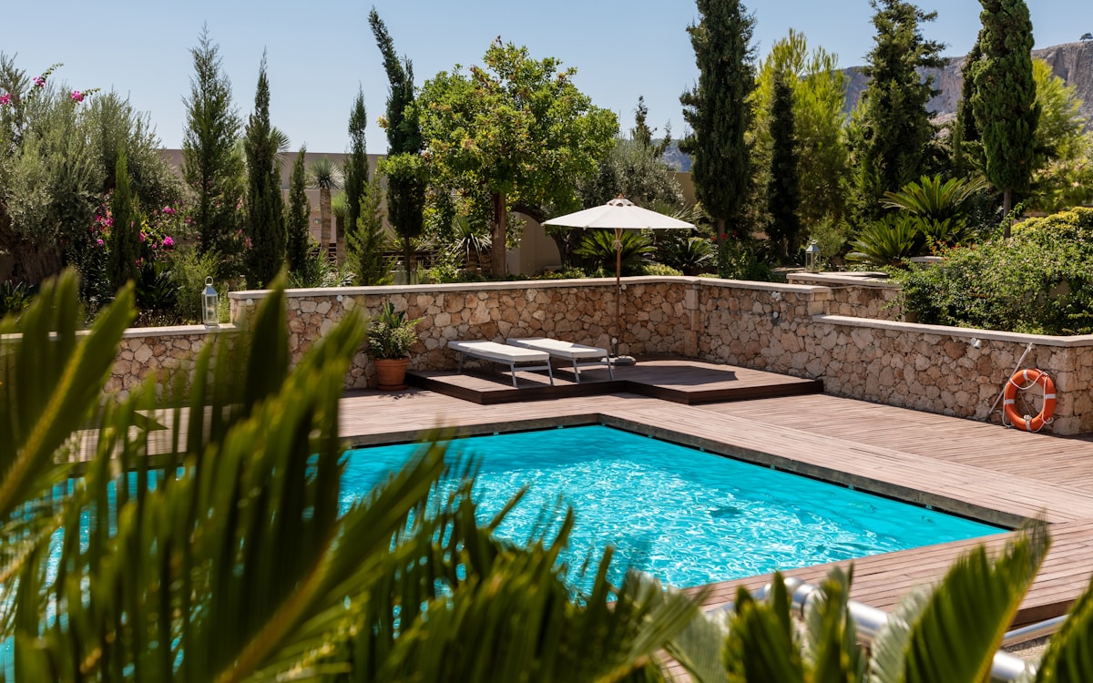 Crystal-clear backyard pool with wooden deck